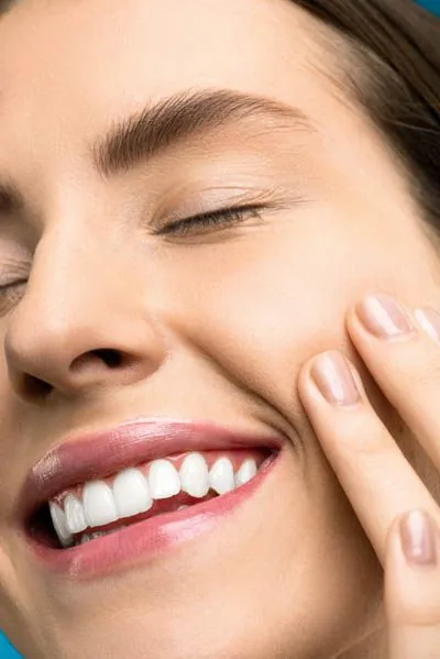 woman smiling pain-free after esthetic injections helped her TMJ