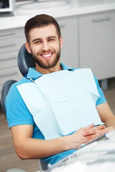 patient smiling after getting an oral surgery procedure at Comfort Dental Meadowbrook