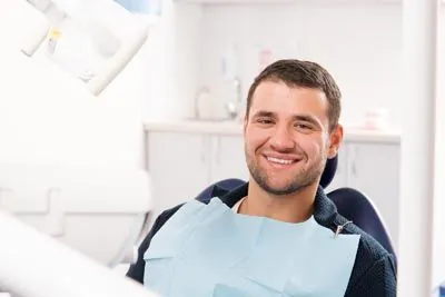 man smiling in the dental chair at Comfort Dental Meadowbrook